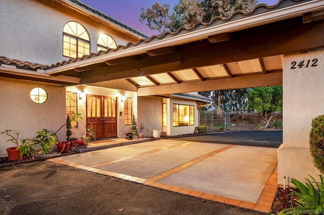 exterior entry at dusk with a patio area