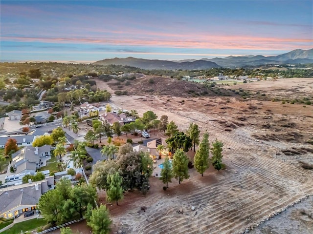 aerial view at dusk featuring a mountain view