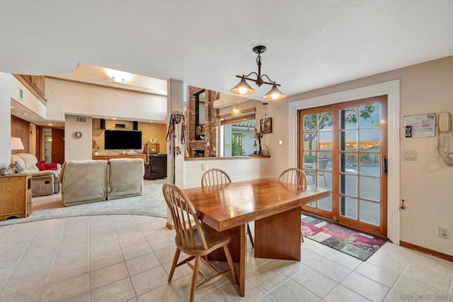 tiled dining space featuring a chandelier