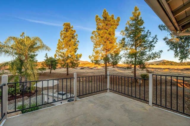 view of patio with a mountain view and a balcony