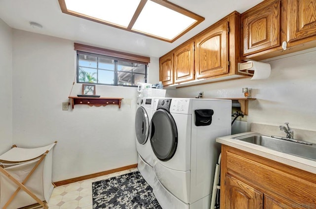 laundry area with cabinets, sink, and washing machine and clothes dryer