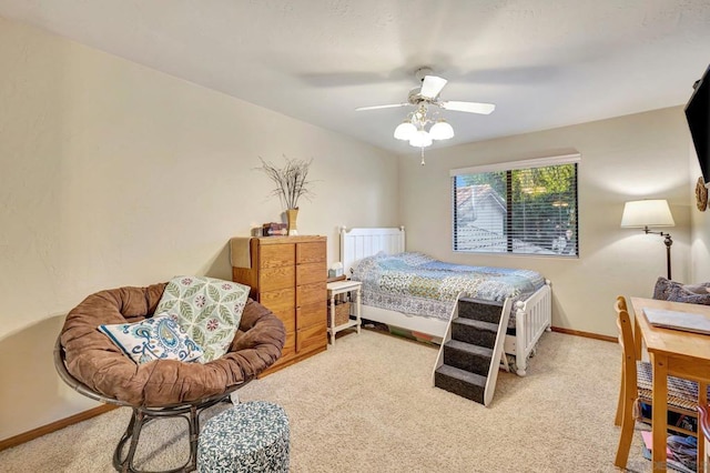 bedroom with ceiling fan and light carpet