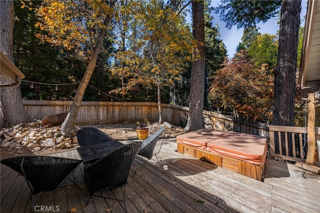 wooden deck featuring a covered hot tub