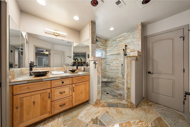 bathroom with vanity, tile walls, walk in shower, and ceiling fan