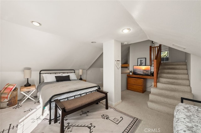 bedroom with light carpet and vaulted ceiling