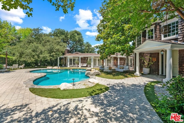 view of pool featuring a patio area