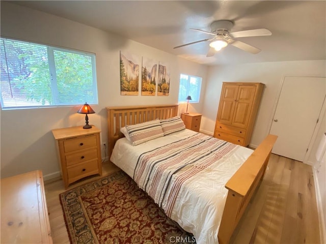 bedroom with ceiling fan and light hardwood / wood-style floors