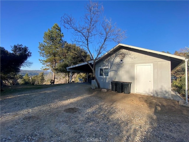 view of side of property featuring a carport