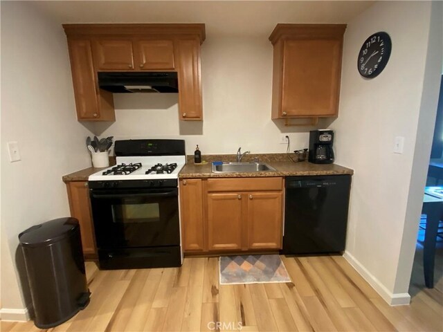 kitchen with gas range gas stove, dishwasher, light hardwood / wood-style flooring, and sink