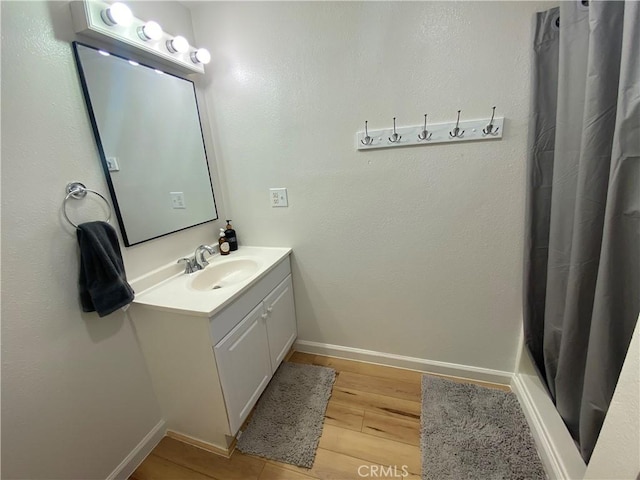 bathroom with vanity and hardwood / wood-style flooring