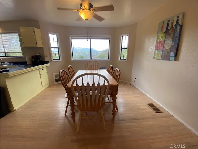 dining space featuring ceiling fan and light hardwood / wood-style floors