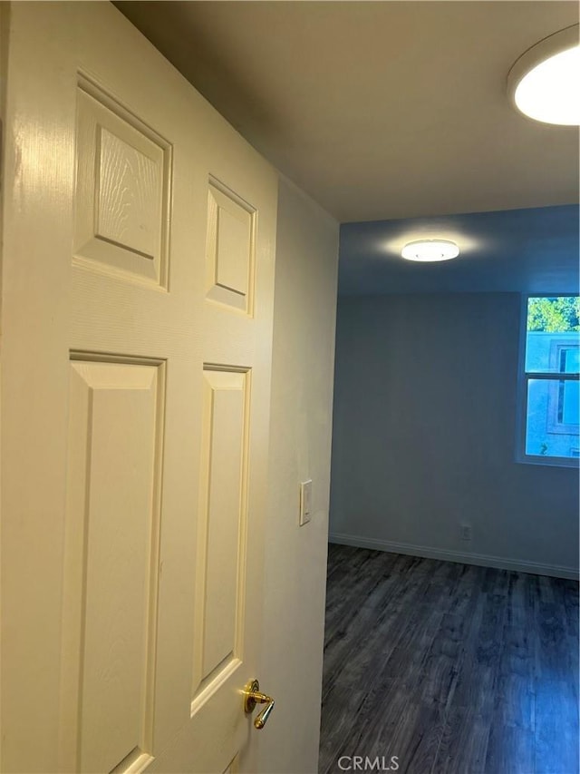 corridor with dark wood-type flooring