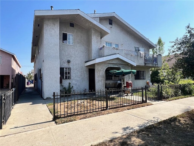 view of front of home featuring a balcony