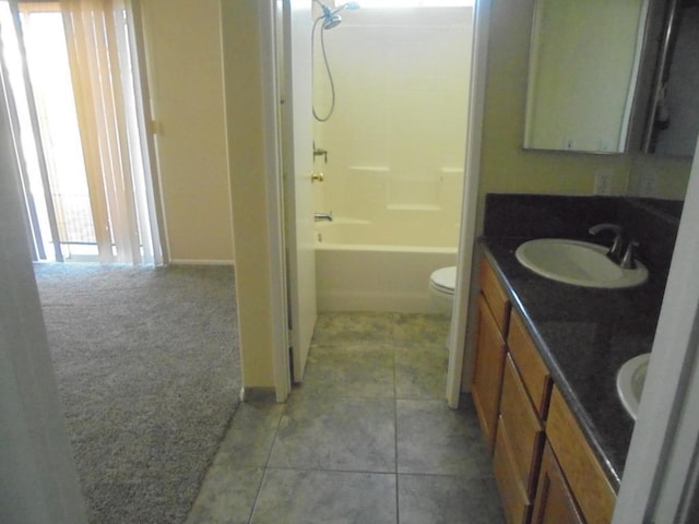 full bathroom with shower / bathing tub combination, tile patterned floors, vanity, and toilet