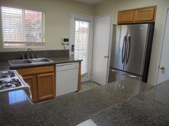 kitchen featuring white appliances and sink