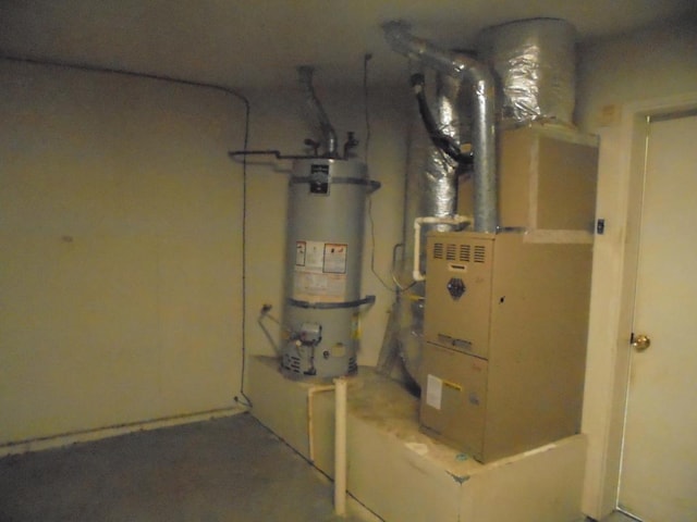 utilities featuring strapped water heater and heating unit