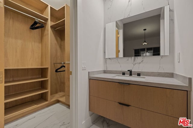 bathroom featuring vanity and tasteful backsplash