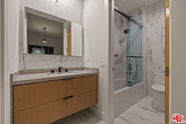 full bathroom featuring toilet, vanity, and combined bath / shower with glass door