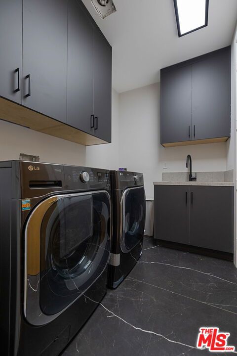 laundry area featuring cabinets and washing machine and dryer