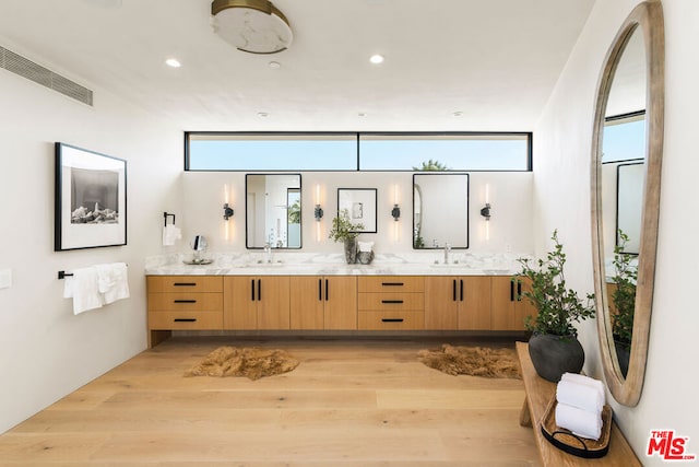 bathroom with hardwood / wood-style flooring, vanity, and decorative backsplash