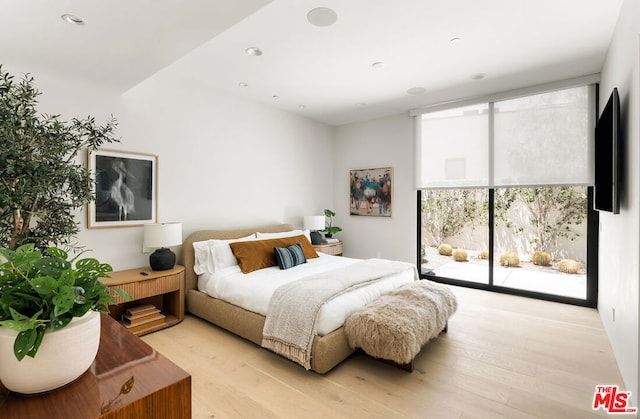 bedroom featuring access to outside and light hardwood / wood-style flooring