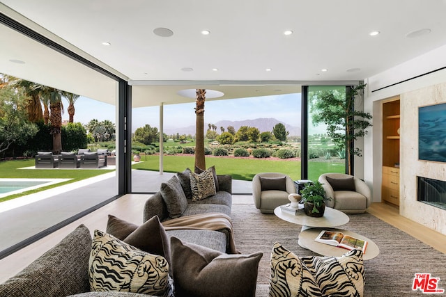 living room featuring light hardwood / wood-style floors and a wall of windows