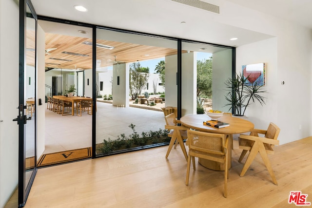 entryway with light hardwood / wood-style flooring, floor to ceiling windows, wooden ceiling, and ceiling fan