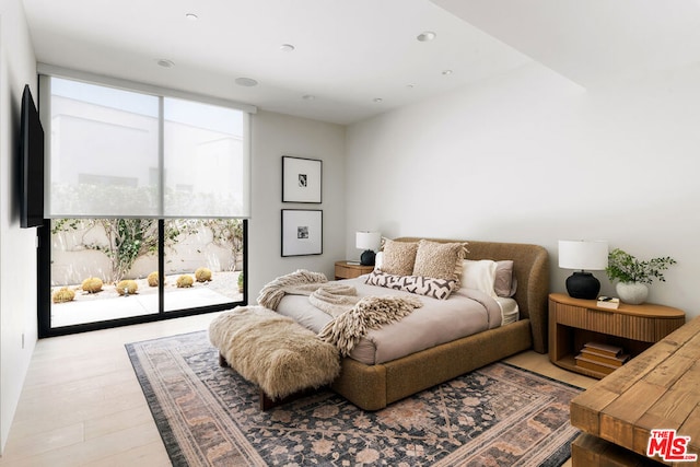 bedroom with access to exterior and light wood-type flooring