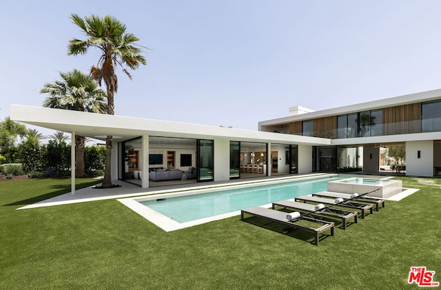 view of pool with a lawn, an outdoor living space, and a patio