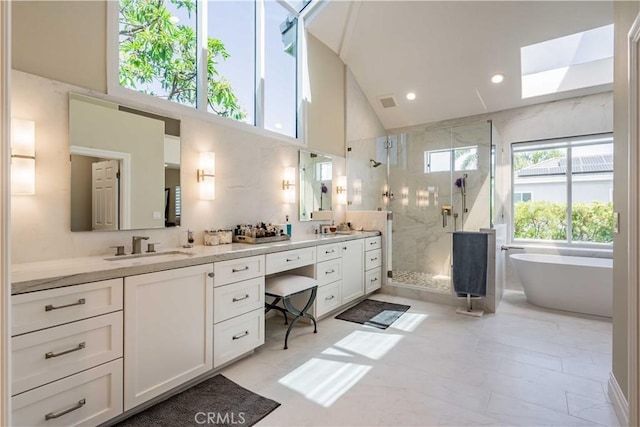 bathroom featuring high vaulted ceiling, vanity, and independent shower and bath