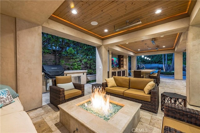 view of patio / terrace with an outdoor living space with a fire pit and a grill