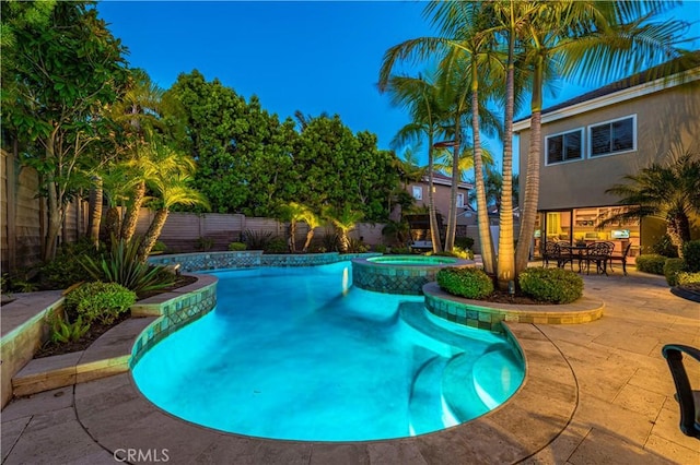 view of swimming pool with an in ground hot tub and a patio