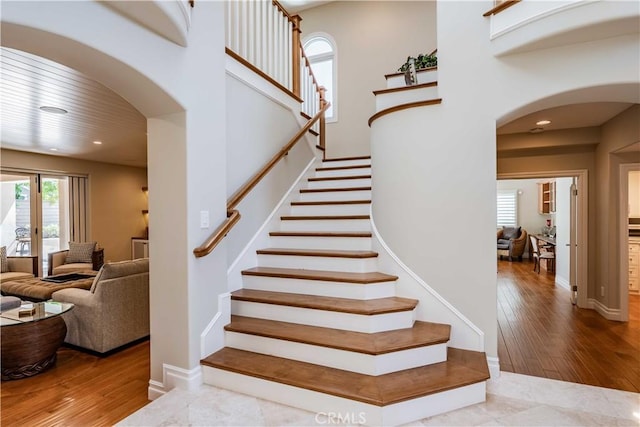 staircase with hardwood / wood-style flooring