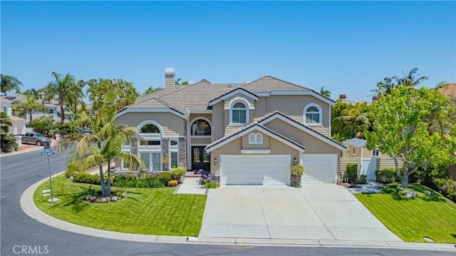 front of property featuring a garage and a front lawn