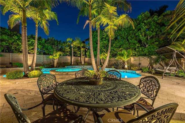 view of patio with a pool with hot tub