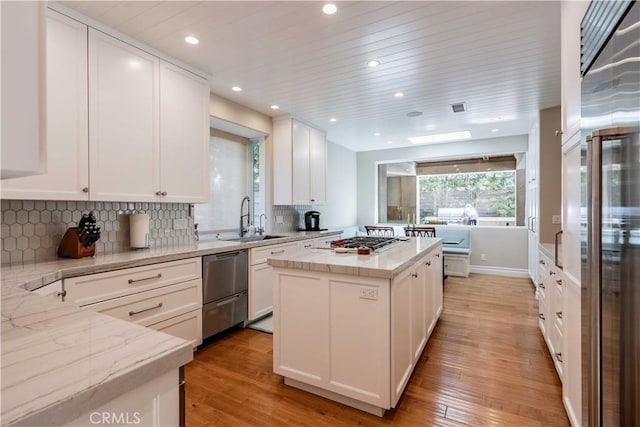 kitchen featuring a center island, white cabinetry, and light hardwood / wood-style flooring