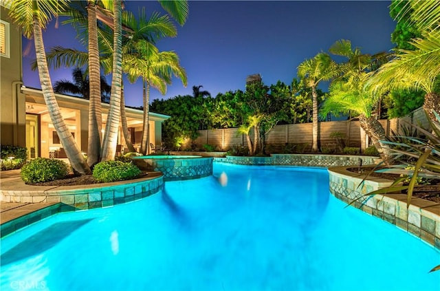 view of pool with an in ground hot tub