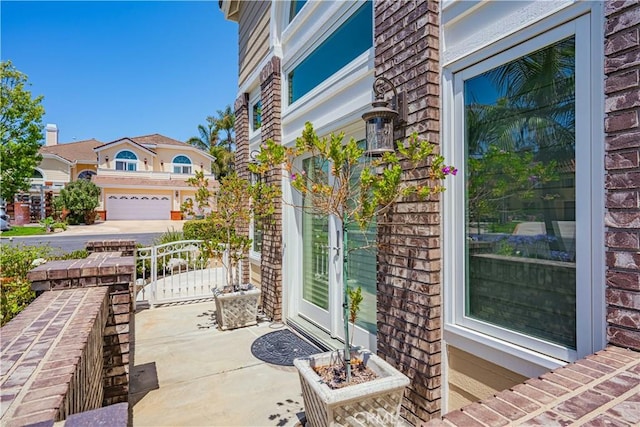 view of patio / terrace featuring french doors and a garage