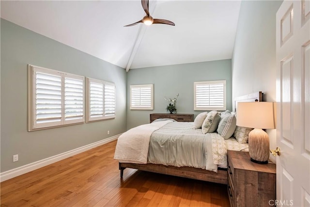 bedroom featuring ceiling fan, wood-type flooring, and vaulted ceiling