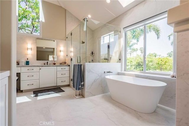 bathroom featuring shower with separate bathtub, vanity, and tile walls