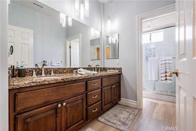 bathroom featuring vanity, hardwood / wood-style flooring, and walk in shower