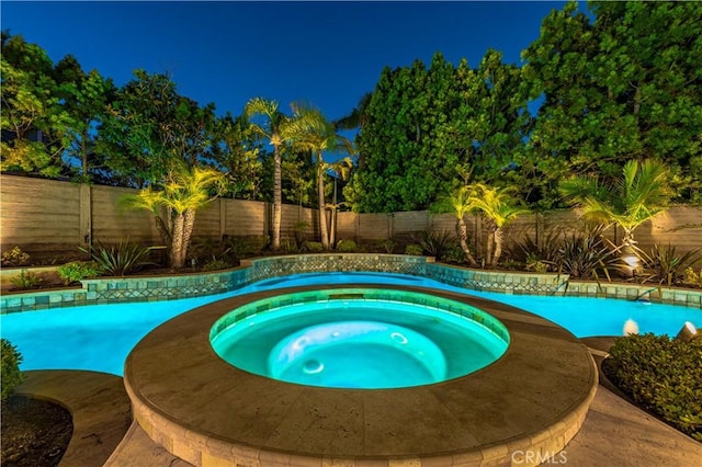 view of pool featuring an in ground hot tub