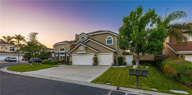 view of front of house featuring a garage and a yard