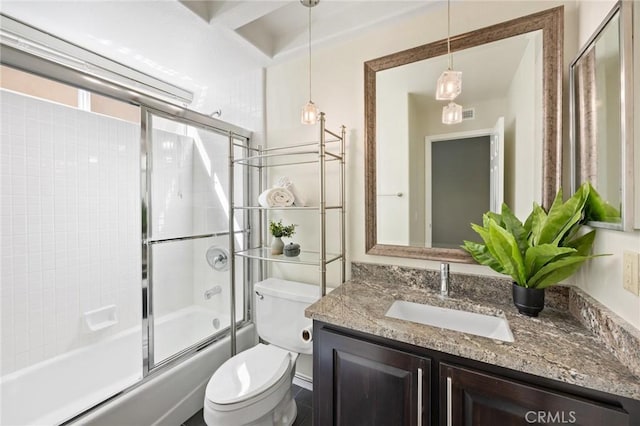 full bathroom featuring enclosed tub / shower combo, vanity, and toilet