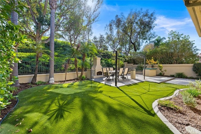 view of yard featuring a patio area and an outdoor fireplace