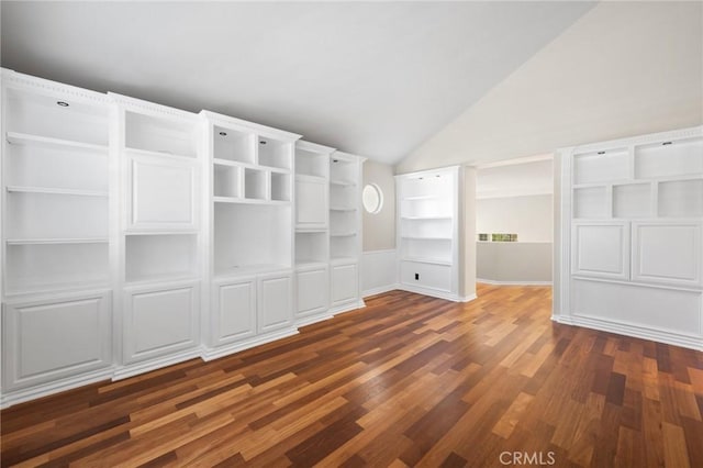 interior space featuring dark wood-type flooring and vaulted ceiling