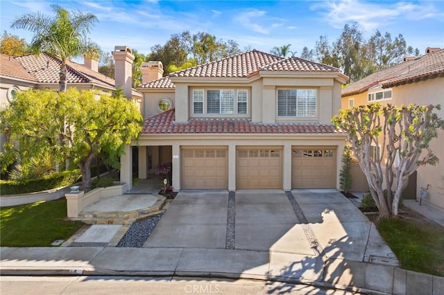 mediterranean / spanish-style home with a garage