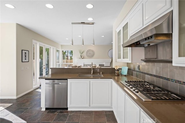 kitchen featuring stainless steel appliances, sink, white cabinets, and kitchen peninsula