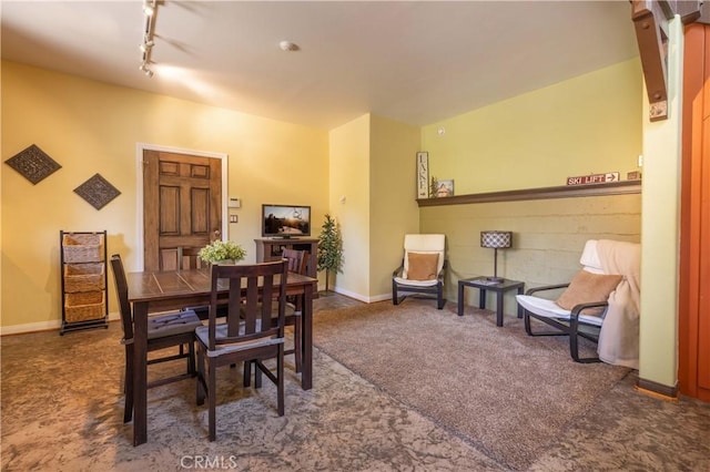 carpeted dining room featuring track lighting