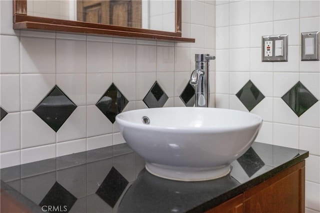 bathroom featuring decorative backsplash, vanity, and tile walls